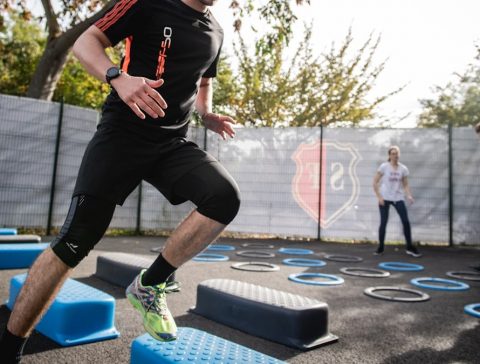 man in black crew neck t-shirt and black shorts running on blue and white trampoline